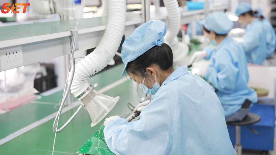 Elumotive technicians assembling power electronics for EV charging power quality applications